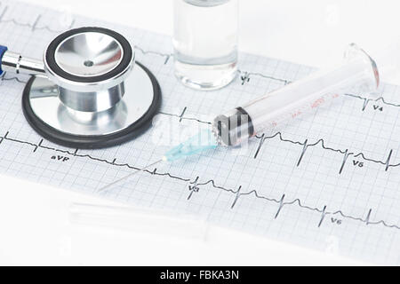 Elektrokardiogramm Graph und Stethoskop mit Spritze und Fläschchen. Stockfoto