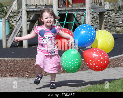 Kleines Mädchen mit Luftballons in einer Gärtnerei Stockfoto