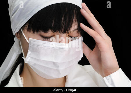 Closeup Portrait eines jungen müde Arztes trägt eine Maske Stockfoto