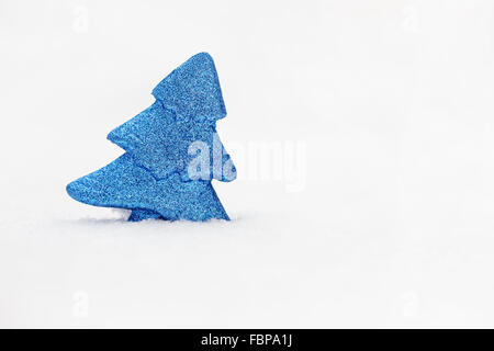 Minimalistische Foto Blau Spielzeug Baum auf echtem Schnee am Wintertag. Stockfoto