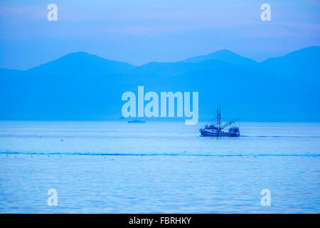 Fischerei Trawler in der Abenddämmerung in Straße von Juan De Fuca mit Hintergrund der Olympischen Range, Vancouver Island, Kanada Stockfoto