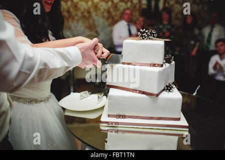 Braut und Bräutigam ist schneiden Kuchen Stockfoto