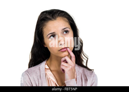 Nachdenkliche Frau mit Finger im Mund Stockfoto