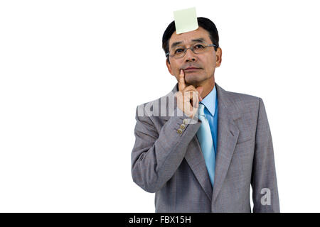 Geschäftsmann mit leere Notiz auf Stirn Stockfoto