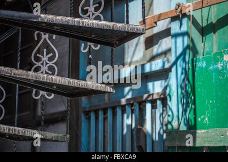 Reich verzierte schmiedeeiserne Wendeltreppe und Geländer detail mit kontrastierenden Licht und Schatten.  Hohen Main street Bomdila, Indien. Stockfoto