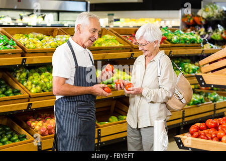 Ältere Kunden und Arbeitnehmer diskutieren Gemüse Stockfoto