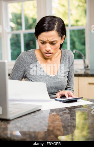 Besorgt Brünette zählen Rechnungen Stockfoto