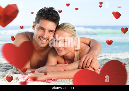 Zusammengesetztes Bild Liebespaar am Strand liegend Stockfoto