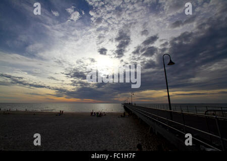 Adelaide, Australien. 20. Januar 2016. Die Menschen gehen im Glenelg Steg Anlegestelle Adelaide gegen eine Entwicklung farbenfrohen Sonnenuntergang Credit Silhouette ist: Amer Ghazzal/Alamy Live-Nachrichten Stockfoto