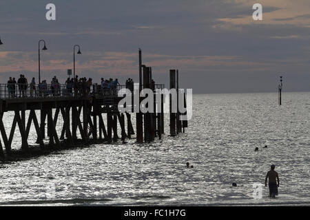 Adelaide, Australien. 20. Januar 2016. Die Menschen gehen im Glenelg Steg Anlegestelle Adelaide gegen eine Entwicklung farbenfrohen Sonnenuntergang Credit Silhouette ist: Amer Ghazzal/Alamy Live-Nachrichten Stockfoto