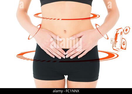 Zusammengesetztes Bild von Closeup Mittelteil einer Fit Frau mit Magenschmerzen Stockfoto