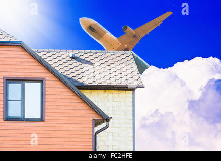 Flugzeuge fliegen über das Dach des Hauses Stockfoto