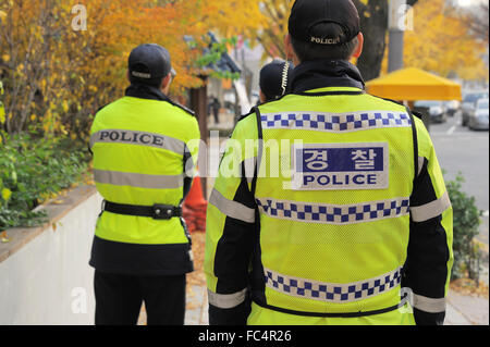 Drei Polizisten gesehen von der Rückseite an einer Straßenecke in Seoul, Südkorea Stockfoto