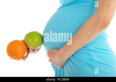 Schwangere Frau Bauch, Apfel und orange Stockfoto