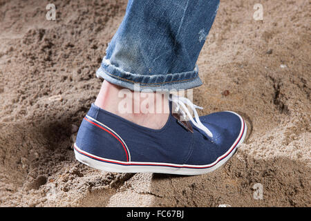 Mannes Beine und Fußabdruck im Sand Stockfoto