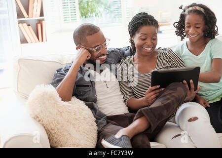 Schwarze Familie mit digital-Tablette auf sofa Stockfoto