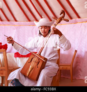 Junger Mann in traditioneller Kleidung spielt Pferd Kopf Geige in einem Ger, Wüste Gobi, Mongolei, Zentralasien Stockfoto