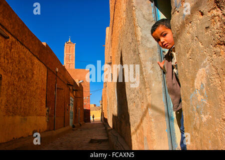 Algerien, Sahara, Hoggar (Ahaggar Berge), Tamanrasset Child Beobachtung aus starten zu Hause in einem von der Straße Tamanrasset Stockfoto