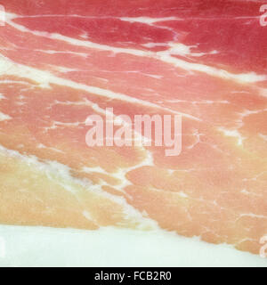 Italienische Schweineschinken Prosciutto oder Aufschnitt Hintergrundtextur hautnah. Schinken ist ein Grundnahrungsmittel-Produkt von Italien. Stockfoto