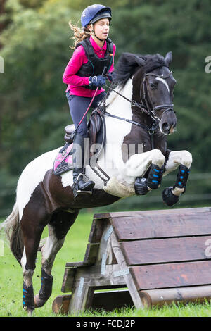 Pinto-Pony. Mädchen auf einem Skewbal Pony, die Verhandlungen über ein Hindernis während der Langlauf Fahrt. Deutschland Stockfoto