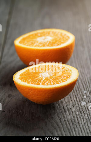 zwei Hälften der Reife Orange auf Holztisch Stockfoto