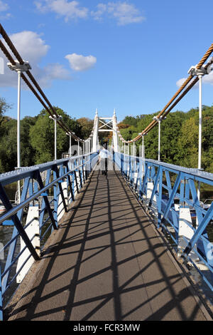 Mann auf Fußgängerbrücke überqueren den Fluss Themse in Teddington, London, UK. Stockfoto