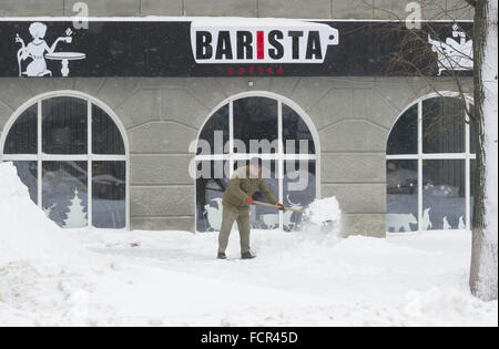 Charkiw, Ukraine. 18. Januar 2016. Ein Mann schaufelt Schnee auf einem Bürgersteig vor einem Café in Charkow, Ukraine, 18. Januar 2016. Foto: Soeren Stache/Dpa/Alamy Live News Stockfoto