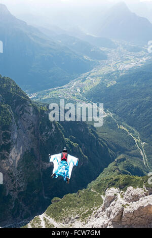 Dieses Wingsuit BASE-Jumper verlassen nur von einer Klippe hinunter ins Tal. Er werde seinen Fallschirm kurz vor Schlag den Boden öffnen. Stockfoto