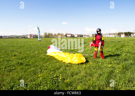 Dieses skydiver Mädchen landete auf ihre Füße, die in der dedizierten Rasen. Sie kann es nicht glauben, dass Sie diesen Sprung und ist jetzt sparen! Stockfoto