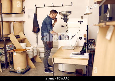 Besitzer einer Kaffee Rösterei überprüfen Bohnen Qualität Stockfoto