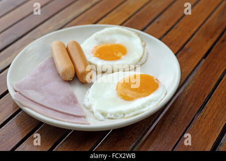 Frühstück Essen mit Schinkenwurst und Ei auf hölzernen Hintergrund Stockfoto