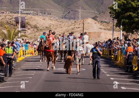 Reiter und ihre Pferde Parade entlang der Straße zum Strand La Enramada wo sie die Tiere Bad werden. Fiesta von San Seba Stockfoto