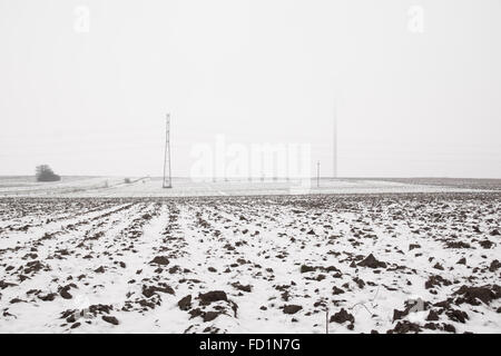 Winterlandschaft mit Windmühle Turbine in Wolken Stockfoto