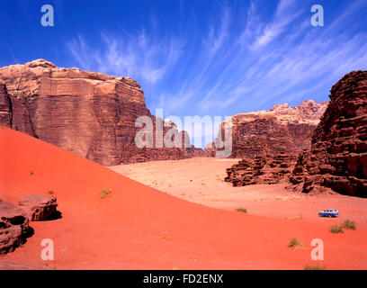 Allradantrieb in Wadi Rum, Jordanien. Blauer Himmel verblasst, roter Sand mit Touristen in 4wd auf einer Tour in dieser Wüste. Stockfoto