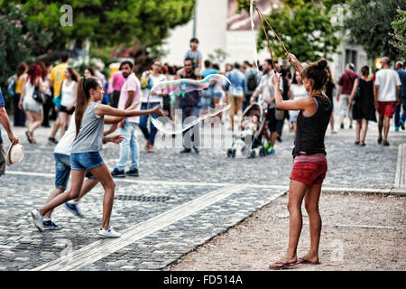 Kleine Kinder spielen mit riesige Seifenblasen in den Straßen von Athen, Griechenland Stockfoto