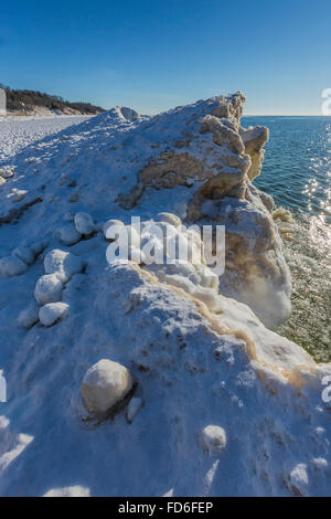 Eiskugeln in der Brandung, dann gefrorene Solid als Teil des Eises See am Rande des Lake Michigan in rosigen Hügel natürlichen Umgebung ausgebildet, Stockfoto