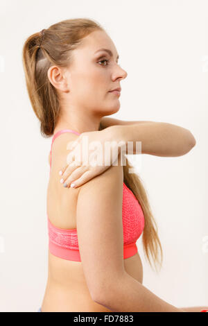 Frau trägt Sportbekleidung fit Fitness Mädchen verletzten Arm Seitenansicht Salbe Creme aufsetzen. Sport Verletzungen im Gesundheitswesen. Stockfoto