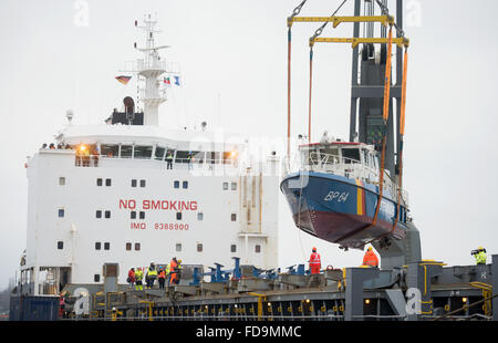 Hamburg, Deutschland. 29. Januar 2016. Das Patrouillenboot BP 64 "Boerde" der Bundespolizei ist auf das Frachtschiff "MV Finesse" in Hamburg, Deutschland, 29. Januar 2016 gehoben. Zwei Boote der Bundespolizei werden an die griechische Küste zur Teilnahme an der Seerettung von Flüchtlingen ab März bereitgestellt werden. Foto: Daniel Reinhardt/Dpa/Alamy Live News Stockfoto