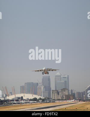 Ein British Aerospace 146 Jet hebt ab Flughafen London City. Canary Wharf und die O2-Arena zeigt im Hintergrund. Stockfoto