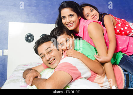 4 Personen Kind und Eltern Schlafzimmer Liegend Entspannung Stockfoto
