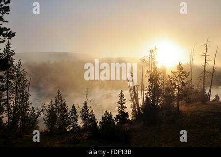 Sonnenaufgang über einen nebligen See Stockfoto