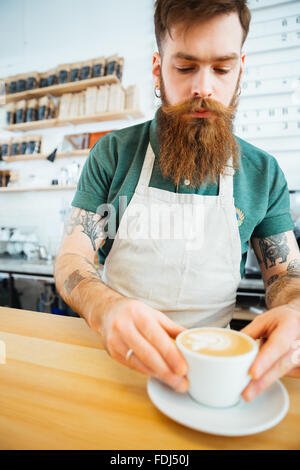 Gut aussehender Mann, die Zubereitung von Kaffee in Coffee-shop Stockfoto
