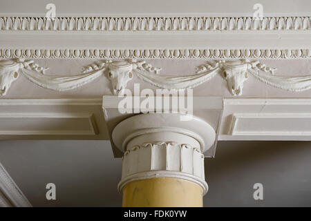 Nahaufnahme der Fries und ein Teil der dorischen Säulen in der Eingangshalle im Newark Park, Gloucestershire. Das Fries ist ein sind oder Ochsen-Schädel, Girlanden und Girlande Design. Stockfoto