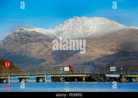 Loch Lomond, UK. 3. Februar 2016. Nach dem jüngsten Stürmen und ungewöhnlich hohen Niederschlägen hatte das Wasser-Niveau bei Luss am Loch Lomond der Begrenzungswände verursacht lokale Überschwemmungen über gekrönt. Am ersten sonnigen Tag Tom und Georgia Wilson aus London, im Urlaub in der Nähe von Luss, nehmen Sie einen entspannenden Spaziergang zu den schneebedeckten Ben Lomond und das ruhige Wasser des Loch Lomond bewundern. Bildnachweis: Findlay/Alamy Live-Nachrichten Stockfoto