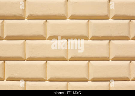 Gelb gefliesten Wand Textur Hintergrund im Sonnenlicht Stockfoto