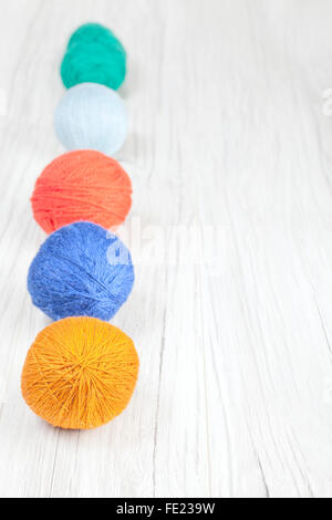 Yarn balls on wooden background, space for text. Stockfoto