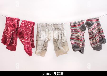 Verschiedene farbige Socken hängen an einem Draht Stockfoto