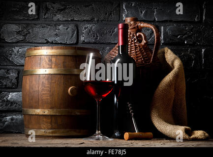 Rotwein auf einem Holztisch im Keller Stockfoto