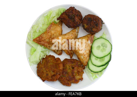 Indische Snacks wie Zwiebel-Bhajis, Samosas und Pakoras auf Platte isoliert auf weiss Stockfoto