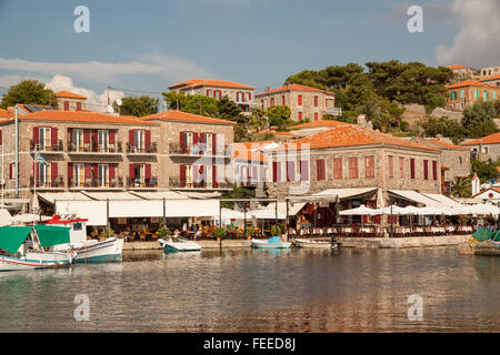 Fischerboote im Hafen an der griechischen Ägäis Resort von Molyvos auf der Insel Lesbos Griechenland mit den Menschen in den Bars und Restaurants. Stockfoto